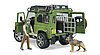 Land Rover Defender with forest ranger and dog